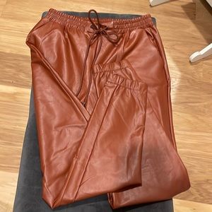 Rust colored faux leather joggers..